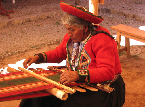 a woman making a tapestry