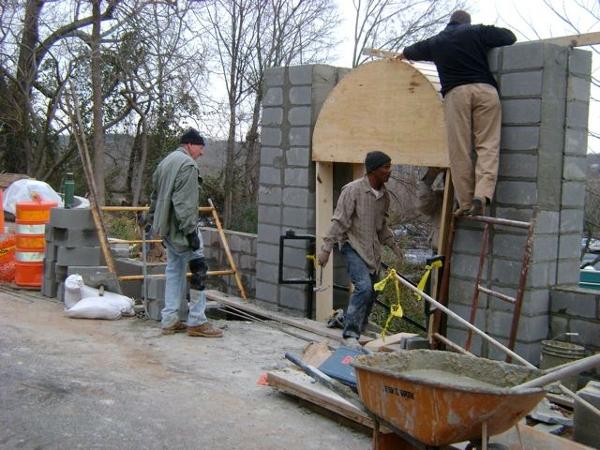 Workers near completion of the arched portion of the upper garden entry portal.