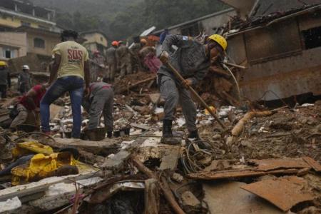 Rescue workers search for victims three days after deadly mudslides. (AP Photo/Silvia Izquierdo)